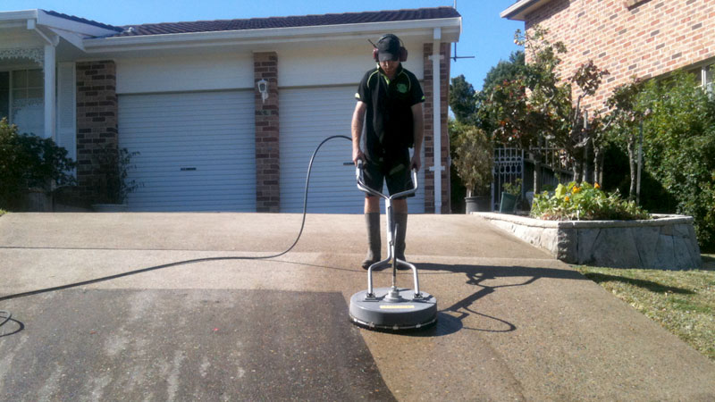 A driveway being pressure cleaned.